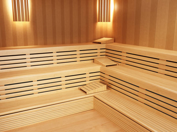 Wooden sauna interior with lighting fixtures on the wall.